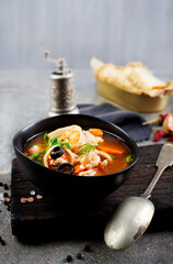 Canvas Print - Pan Asian traditional seafood soup with mussels, calamari, mushrooms served with fresh parsley herbs