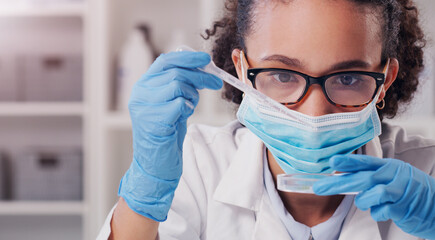 Wall Mural - this test should do it. shot of a young scientist analysing samples in a lab.