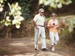 Stretching their legs on a leisurely stroll. A senior couple out for a walk in the forest together.