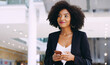 © Yuri Arcurs/peopleimages.com - Its a must have accessory for a modern entrepreneur. Shot of a young businesswoman using a smartphone while walking through a modern office.