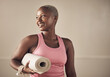 © Tasneem H/peopleimages.com - I just had a great yoga session. Cropped shot of an attractive young woman standing alone and holding her yoga mat before an indoor yoga session.