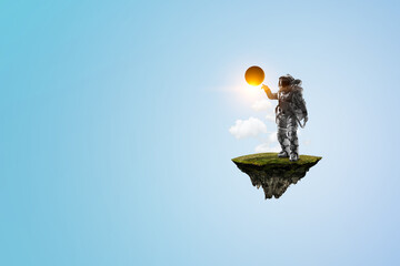 Wall Mural - spaceman on a light bulb