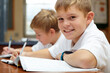 © Tylan E/peopleimages.com - Enjoying his learning experience. Two young schoolboys doing their schoolwork in the classroom.