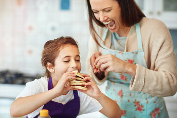 Sticker - I have to have it all. Shot of a mother and daughter preparing food in the kitchen at home.