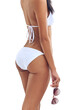 © Delmaine Donson/peopleimages.com - Time to hit the beach. Rearview studio shot of a young woman in a bikini isolated on white.