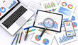© yoshitaka - ビジネス資料とノートパソコン、スマートフォン、筆記用具、虫メガネ、ビジネスシーン