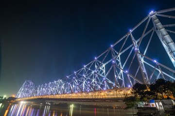 Wall Mural - Howrah bridge on the river Hooghly with the twilight sky. The cantilever bridge is considered the busiest bridge in India.