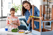© Syda Productions - family, diy and home improvement concept - happy smiling mother and daughter with ruler measuring old wooden table for renovation at home