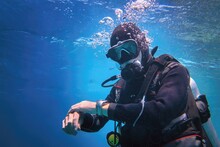 Fully Equipped Man Scuba Diver Underwater In The Blue Water