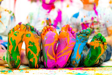 Children's Feet In Multi-colored Paints. Cheerful Childhood. . High Quality Photo