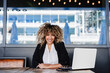 © Eva - smiling hispanic afro business woman in cafe working on laptop and mobile phone. tech and lifestyle