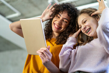 Wall Mural - Group of multiethnic teenagers with modern gadgets and laptop having fun, studying together at home