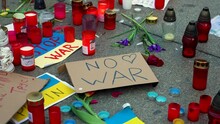 Antiwar Sign, Ukrainian Flags And Candles On The Pavement At A Protest.
