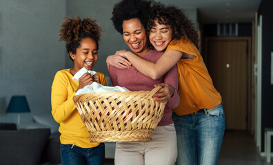 Wall Mural - Happy black children helping for mother do household and domestic chores together