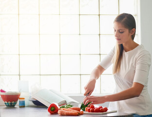 Sticker - Shes all about making healthy and wholesome meals. Cropped shot of a young woman preparing a healthy meal at home.