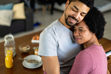 Happy couple having breakfast together in the kitchen