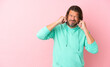 © luismolinero - Senior dutch man isolated on pink background frustrated and covering ears