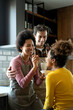© NDABCREATIVITY - Happy multiethnic family in love together in kitchen. Parents child together concept