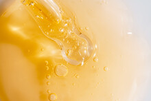 Vitamin C Serum Liquid Texture With Dropper, Macro Shot.