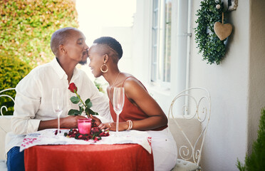 Wall Mural - You deserve to be treated like royalty. Cropped shot of a happy young couple having a romantic dinner outside.