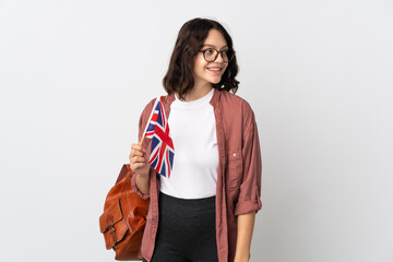 Wall Mural - Teenager Ukrainian girl holding an United Kingdom flag looking side