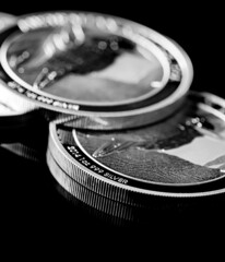 Wall Mural - Close up of  Silver Bullion Coin on a black mirror background