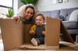 © ReeldealHD images - Mother and Toddler playing with a cardboard box