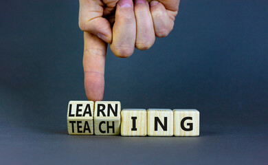 learning or teaching symbol. businessman turns wooden cubes and changes the word teaching to learnin