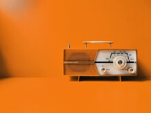 Vintage 50s Transistor Radio, Orange Wall Background, Listen Music Concept