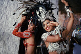 For the joy of samba. Shot of two beautiful samba dancers performing in a carnival.