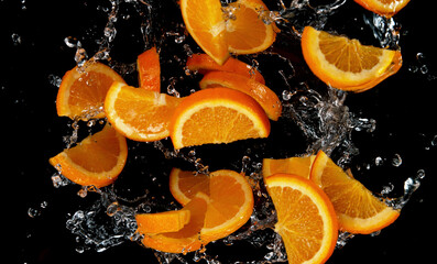 Fototapete - Freeze motion of sliced oranges in water splash.