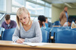 © Nicola Katie/peopleimages.com - The last exam before the real world begins. Shot of a group of university students sitting in a lecture.