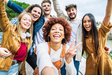 Multiracial Group Of Friends Taking Selfie Pic Outside - Happy Different Young People Having Fun Walking In City Center - Youth Lifestyle Concept With Guys And Girls Enjoying Day Out Together