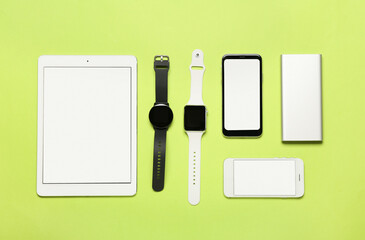 Set of modern gadgets on green background