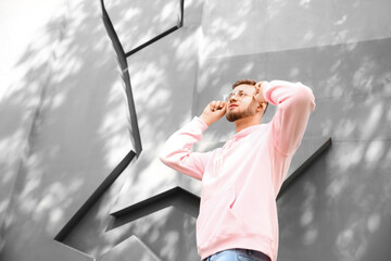 Wall Mural - Young guy in stylish hoodie outdoors