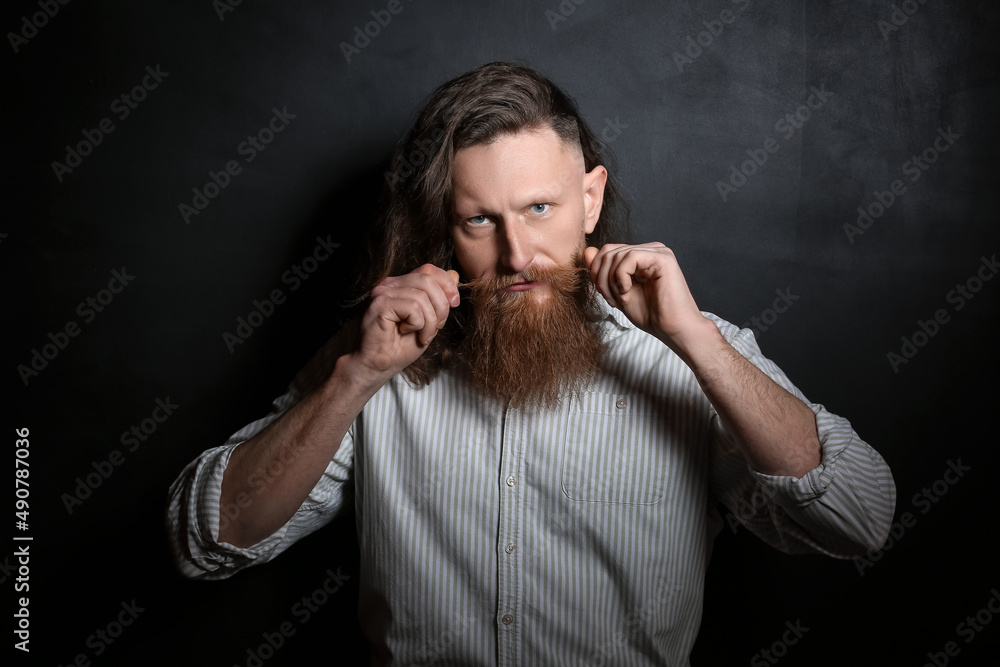 Portrait of handsome bearded man on dark background