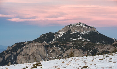 Wall Mural - Snowy mountain landscape at sunset or sunrise