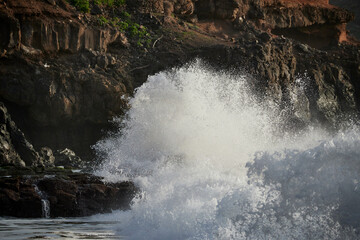 Sticker - Strong bursts of waves against the background of rocky cliffs