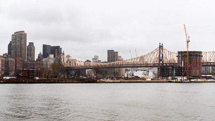 Wall Mural - Beautiful view of The Brookly Bridge and tall buildings by the sea in Manhattan, New York City