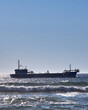 Vertical of a dredging ship cruising on a sunny day near the Barra beach, Aveiro, Portugal