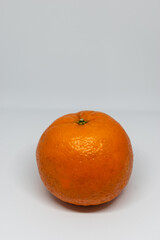 Wall Mural - Vertical shot of an orange fruit isolated on a plain background