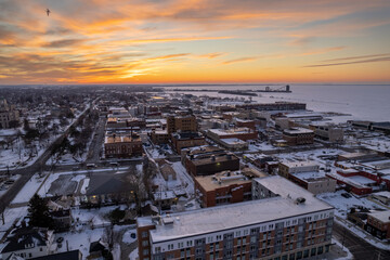 Sticker - Aerial shot of the cityscape with buildings near the sea in winter during sunset