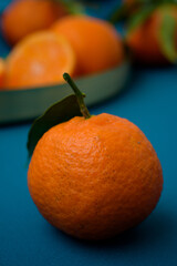 Wall Mural - Vertical shot of fresh juicy tangerine with blurred background