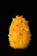 Canvas Print - Closeup shot of a ripe juicy kiwano isolated on a black background