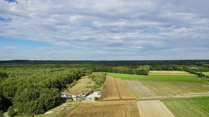 Sticker - Aerial view of a town building and agricultural fields under a cloudy sky