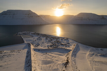 Poster - Beautiful sunset over the frozen lake, the mountains and the snow-covered village