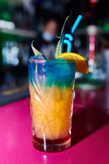 Canvas Print - Vertical shot of a delicious cocktail on a pink table