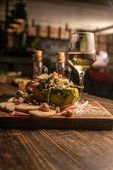 Wall Mural - Closeup of artichokes stuffed with couscous on a wooden board