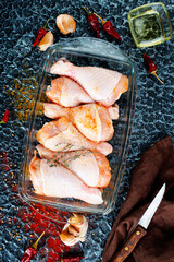 Wall Mural - Raw uncooked chicken legs with ingredients for cooking