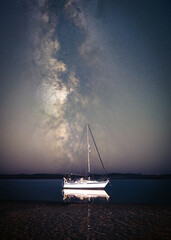 Wall Mural - Isolated boat on the sea in a magical night.